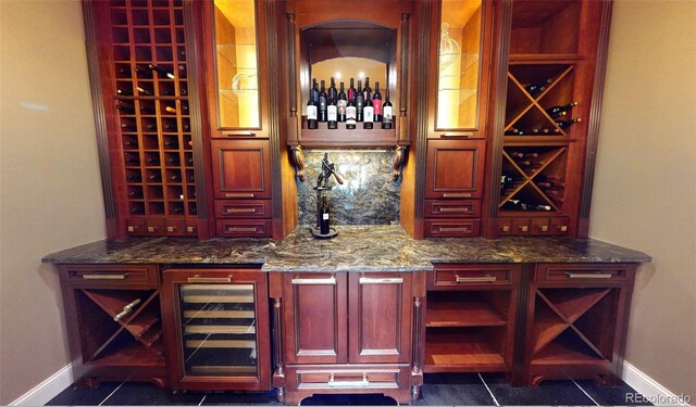 921 County Road 317, Crested Butte, CO 81224 - wine room featuring baseboards, a dry bar, beverage cooler, and dark tile patterned flooring