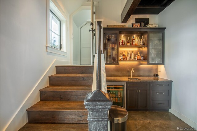 921 County Road 317, Crested Butte, CO 81224 - indoor wet bar with beverage cooler, stairway, baseboards, and finished concrete floors