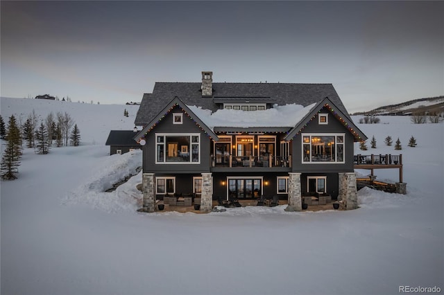 921 County Road 317, Crested Butte, CO 81224 - snow covered house featuring a chimney and a balcony