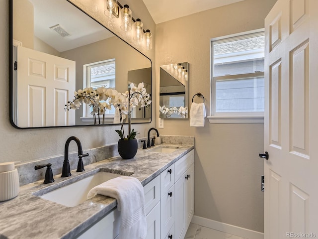 4287 Brookwood Pl, Highlands Ranch, CO 80130 - bathroom with double vanity and marble look tiles