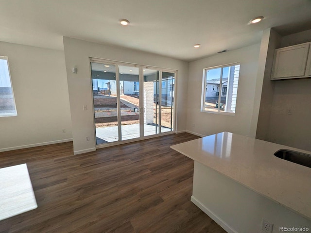 interior space with visible vents, baseboards, dark wood-type flooring, and recessed lighting