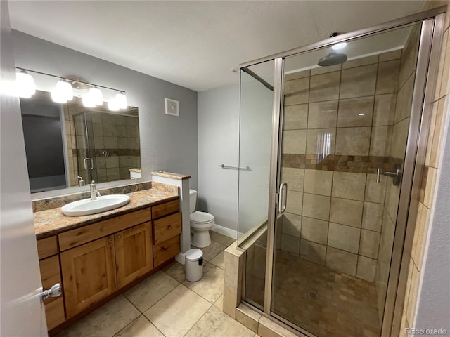 bathroom with toilet, a shower with door, tile patterned flooring, and vanity