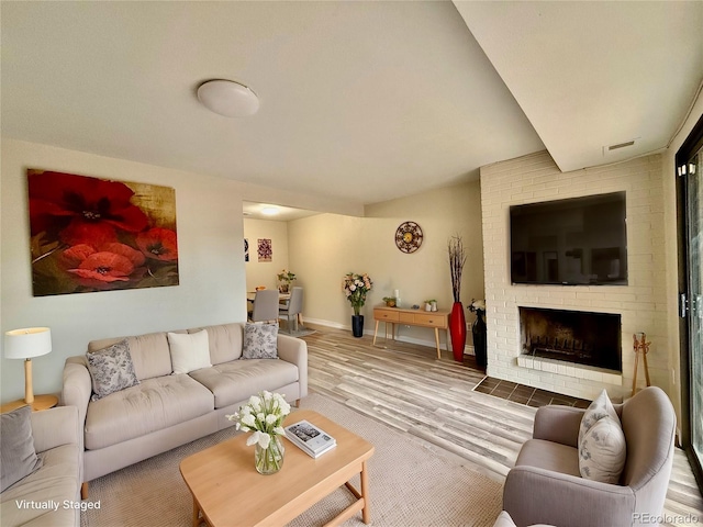 living room with a fireplace and hardwood / wood-style floors