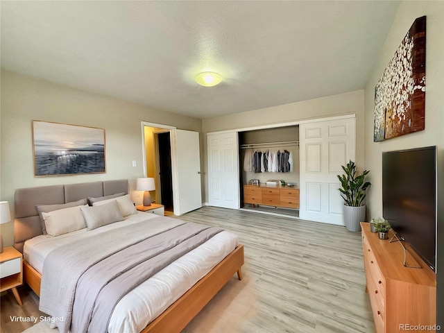 bedroom featuring light hardwood / wood-style floors and a closet