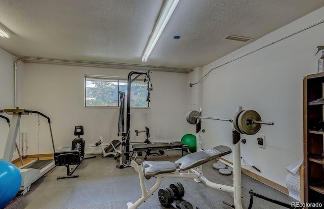 exercise area featuring a textured ceiling