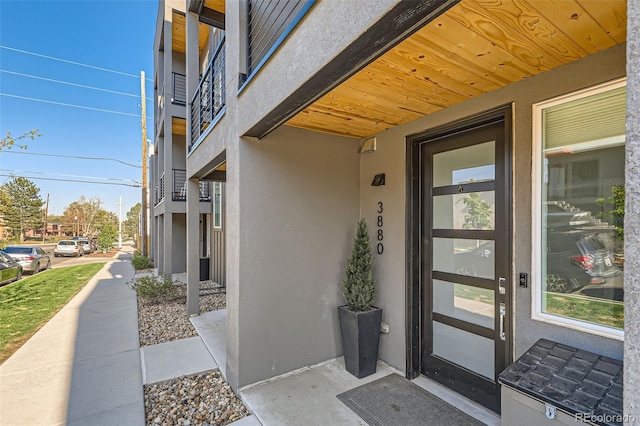 doorway to property with stucco siding
