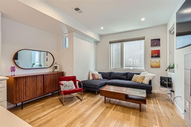 living room featuring light wood-type flooring and recessed lighting
