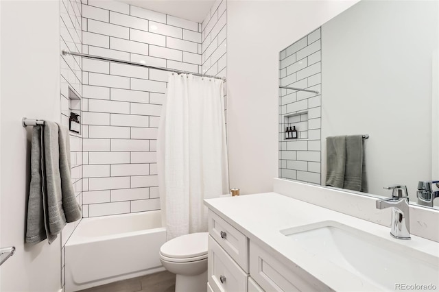 bathroom with toilet, vanity, and shower / tub combo