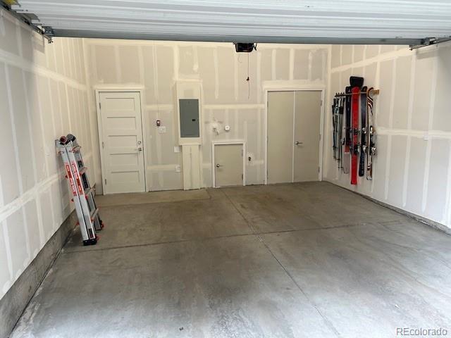 garage featuring a garage door opener and electric panel