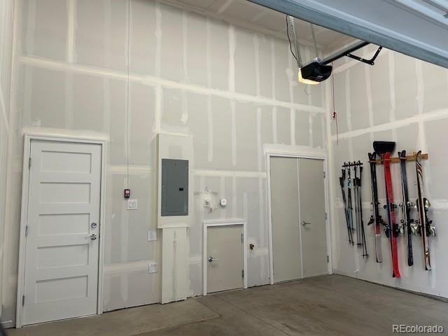 garage featuring electric panel and a garage door opener