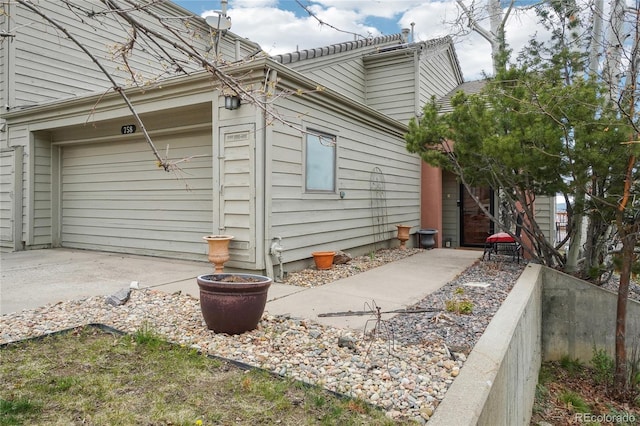 view of home's exterior with an attached garage and driveway