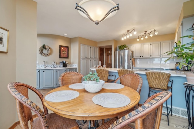 dining space featuring visible vents and light wood-style floors