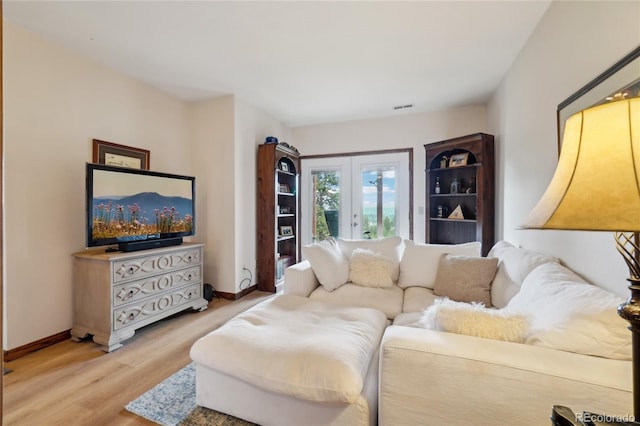 living room with baseboards, wood finished floors, and visible vents