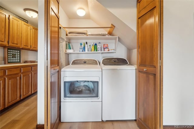 laundry area featuring light wood-style floors, laundry area, and washer and dryer