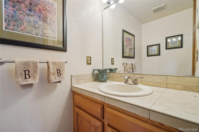 bathroom featuring vanity and visible vents