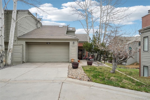 view of front of home with a garage, driveway, and a tile roof