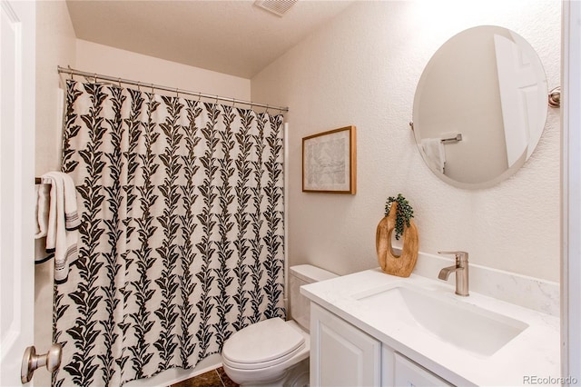 bathroom with toilet, a shower with curtain, visible vents, and vanity