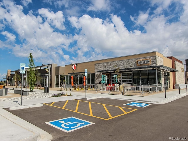 view of property featuring uncovered parking
