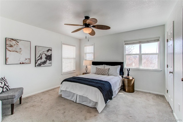 bedroom with baseboards, a ceiling fan, and light colored carpet