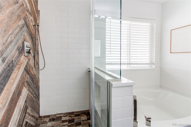 full bath with a bath and tiled shower