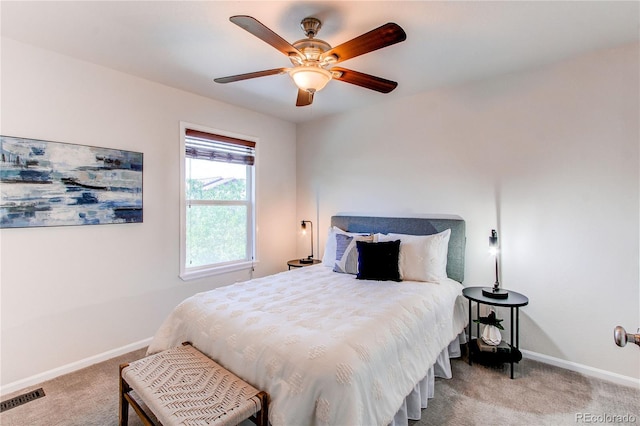 bedroom featuring light colored carpet, a ceiling fan, baseboards, and visible vents