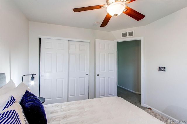bedroom featuring carpet flooring, ceiling fan, baseboards, visible vents, and a closet