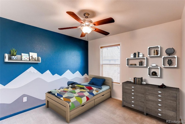 carpeted bedroom featuring baseboards and a ceiling fan