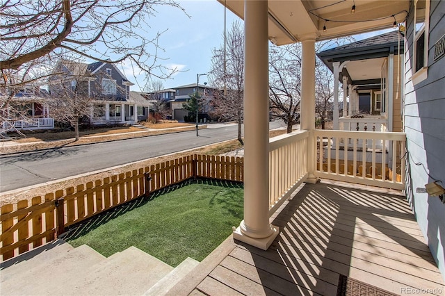 deck with a residential view and covered porch
