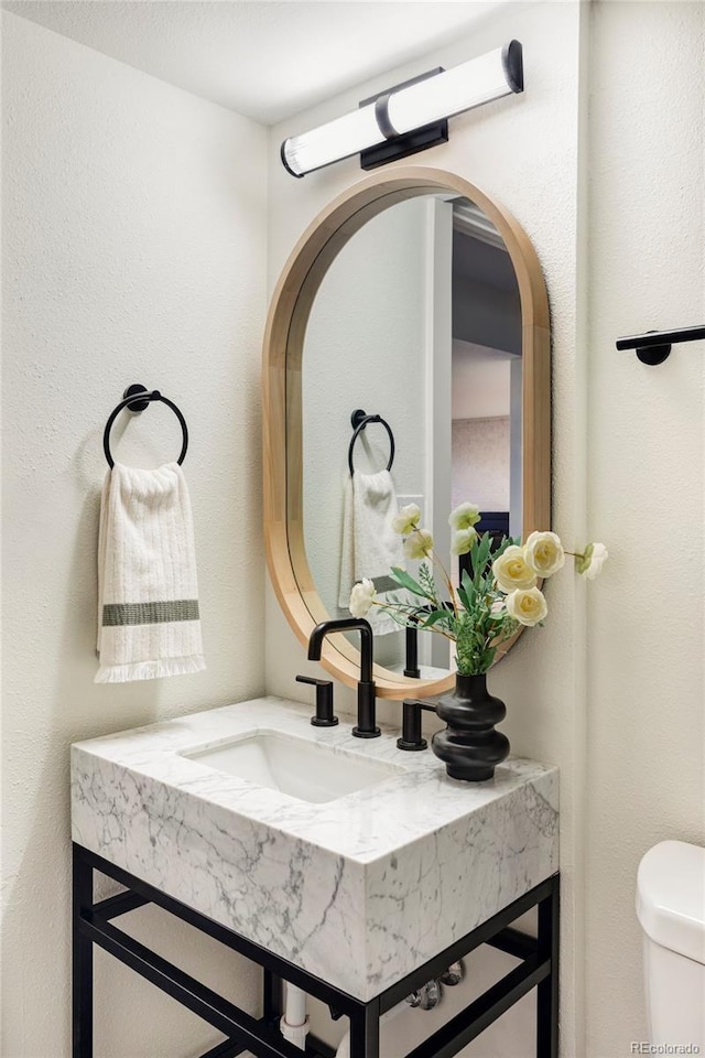 bathroom with toilet and vanity