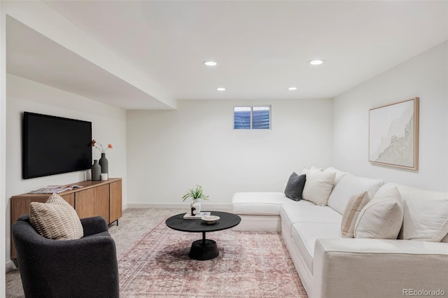 living area with recessed lighting, light carpet, and baseboards