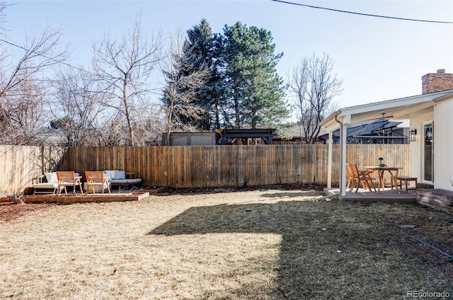 view of yard featuring outdoor lounge area, a fenced backyard, and a wooden deck