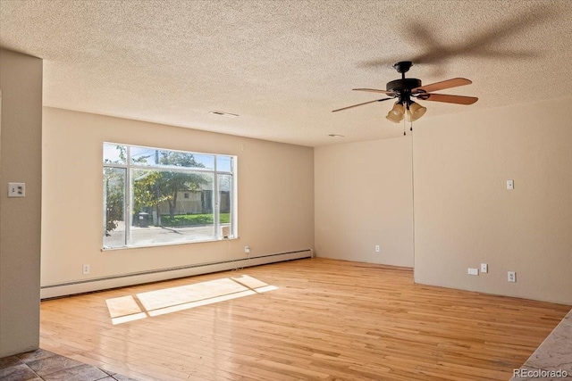 spare room featuring a textured ceiling, a baseboard radiator, a ceiling fan, and wood finished floors