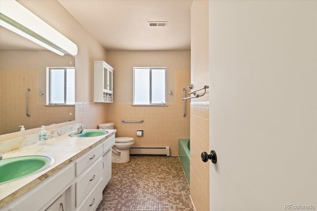 bathroom featuring visible vents, a baseboard radiator, a sink, and toilet