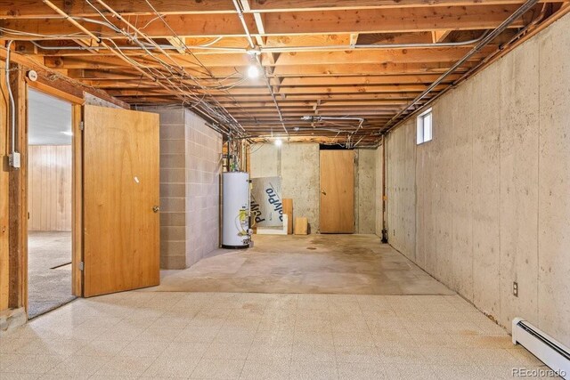 basement featuring a baseboard radiator and gas water heater
