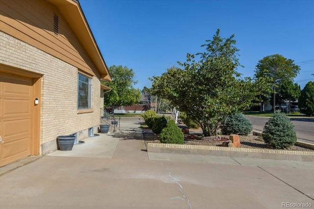 view of property exterior with brick siding