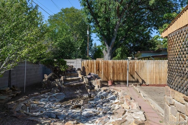 view of yard with a fenced backyard