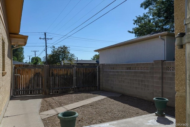 view of yard featuring fence and a gate