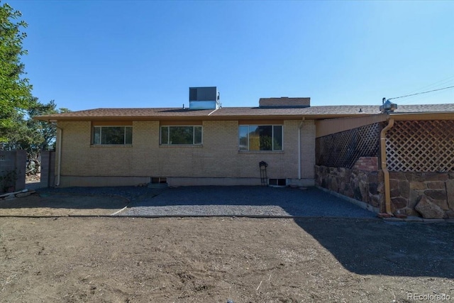 rear view of property featuring brick siding