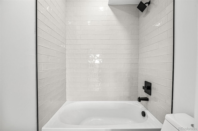 bathroom featuring toilet and bathing tub / shower combination