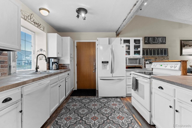 kitchen with white cabinets, dark wood-style floors, a sink, and white appliances