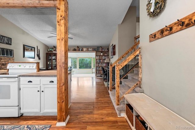 kitchen featuring a textured ceiling, white electric range, ceiling fan, wood finished floors, and white cabinets