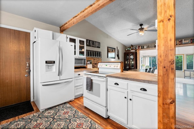 kitchen with wood finished floors, a ceiling fan, vaulted ceiling with beams, white cabinets, and white appliances
