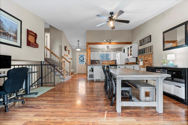 interior space with ceiling fan, a textured ceiling, and light wood-style floors