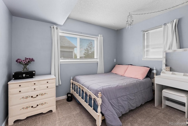 bedroom with carpet and a textured ceiling
