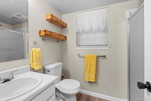 full bathroom with toilet, wood finished floors, vanity, visible vents, and a shower stall