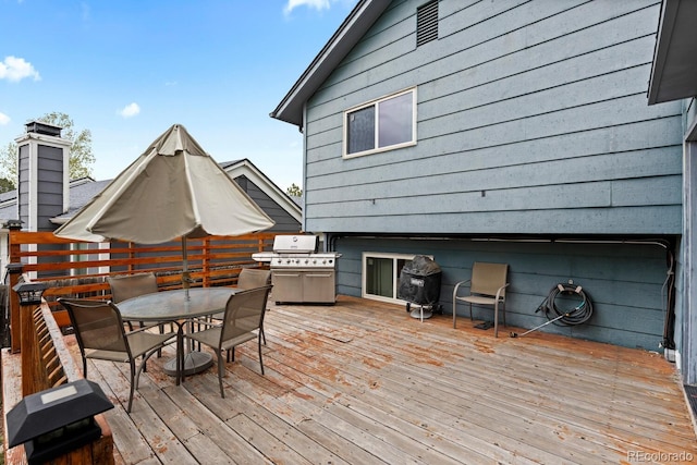 wooden terrace featuring outdoor dining area