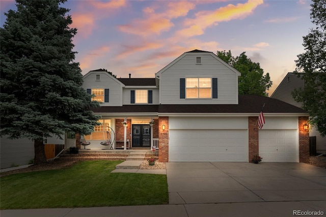 2795 Signal Creek Dr, Thornton, CO 80241 - view of front of property with a porch, brick siding, concrete driveway, a yard, and a garage