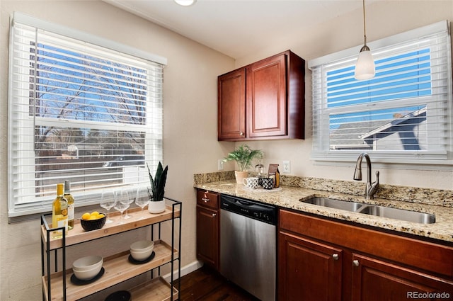 kitchen with a wealth of natural light, sink, hanging light fixtures, light stone counters, and stainless steel dishwasher