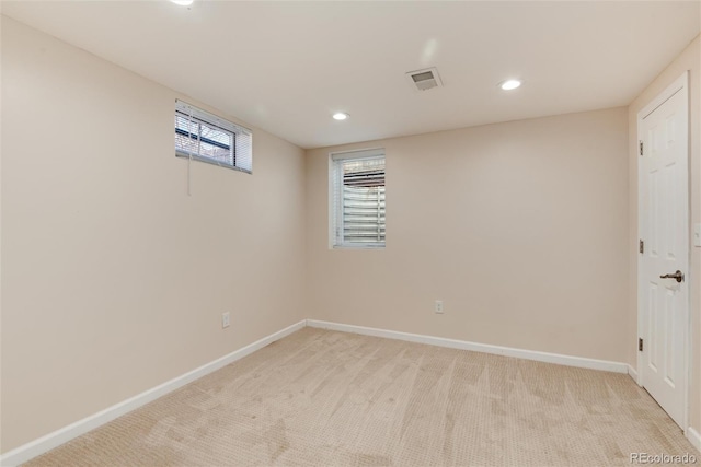 basement featuring light colored carpet