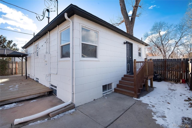 view of snow covered exterior featuring a deck